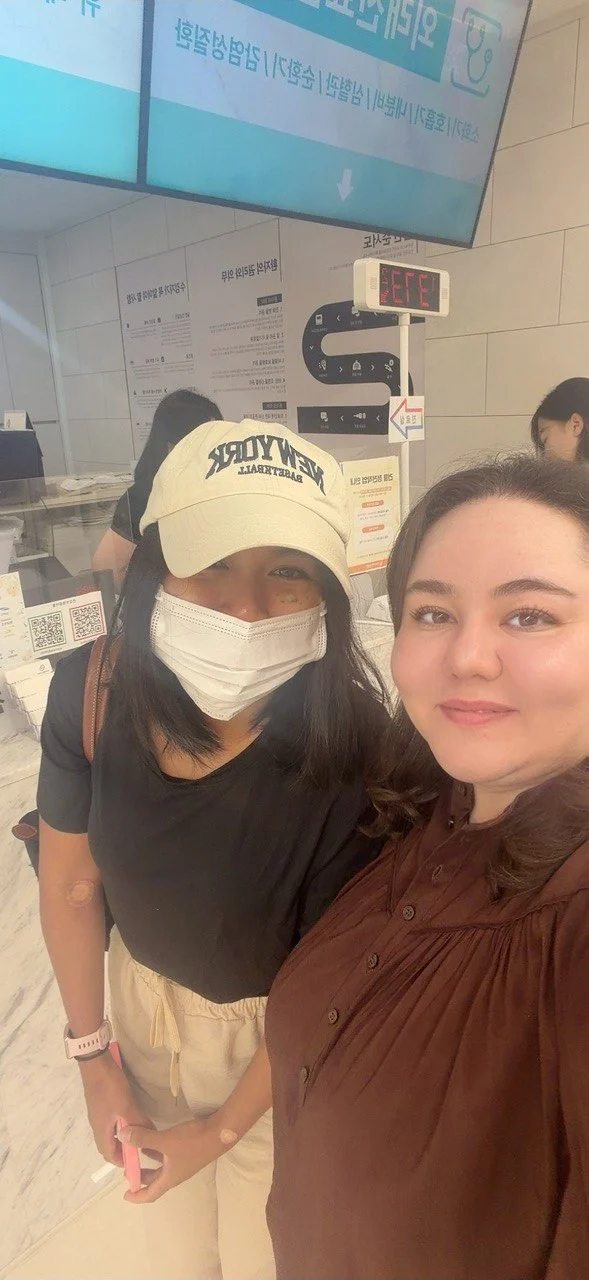 A patient and our coordinator taking a selfie at the clinic check-in desk