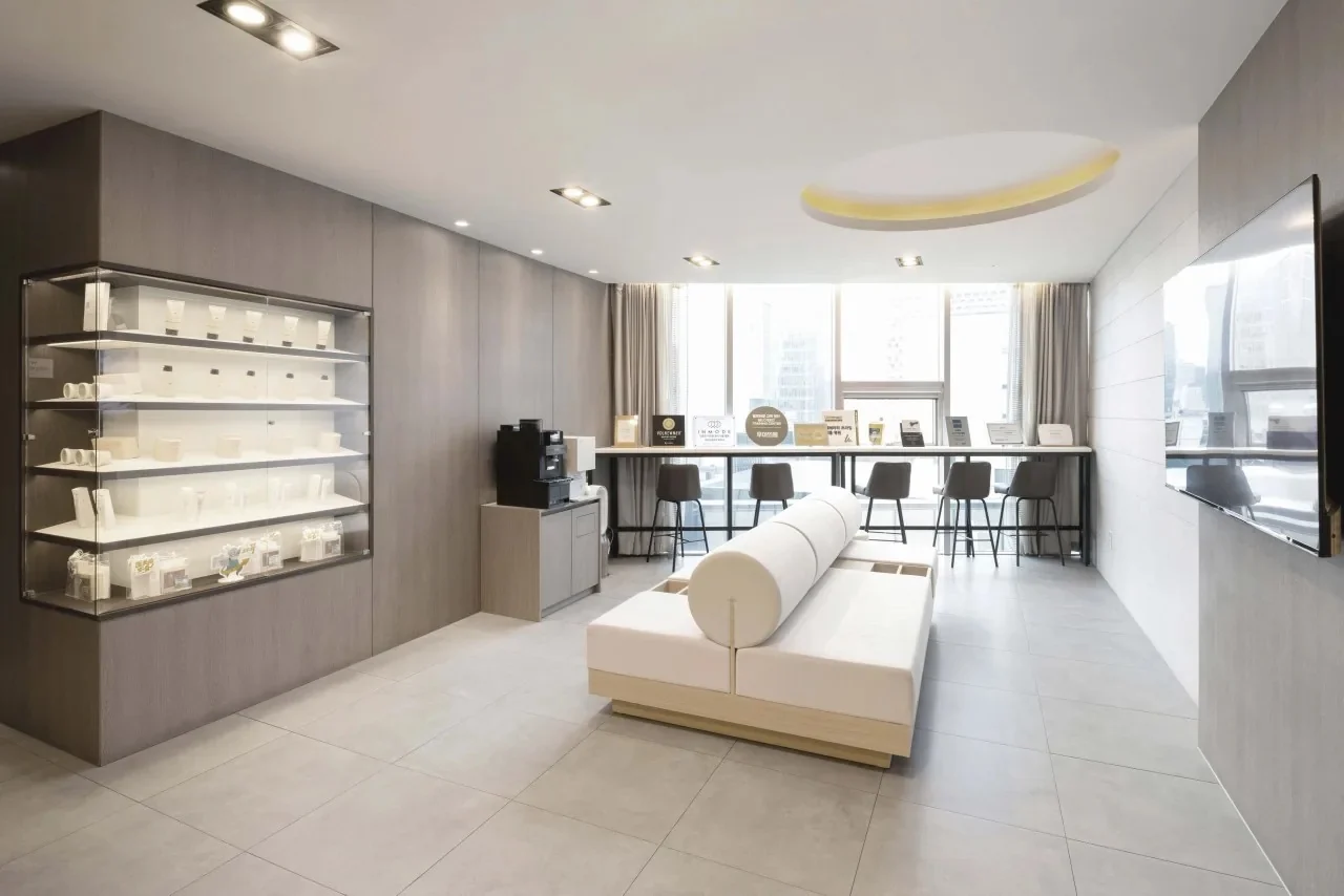 Lounge with a skin-care display and window seats at WOOA